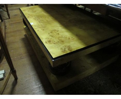 AN ART DECO STYLE BURR WALNUT AND EBONISED COFFEE TABLE the rectangular top raised on spherical supports and platform base 45