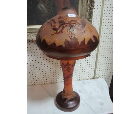 A CONTINENTAL PINK AND RUBY ETCHED GLASS LAMP moulded in relief with flowerheads and foliage with mushroom shade and baluster
