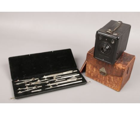 A cased set of Temple drawing instruments and a Kodak Box 620 camera in crocodile effect case. 