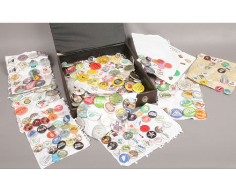 A case of assorted vintage pin badges. 