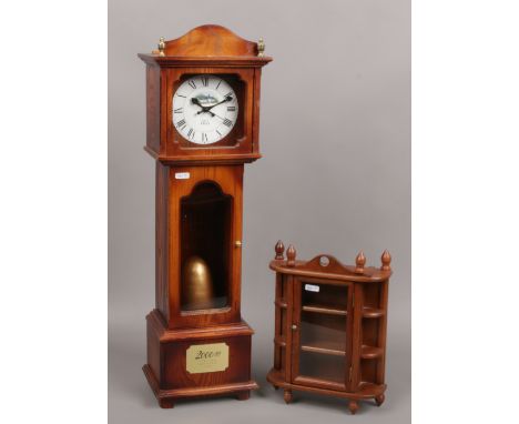 A Glengoyne 200 AD limited edition clock case, height 70cm along with a glazed wooden thimble cabinet. 