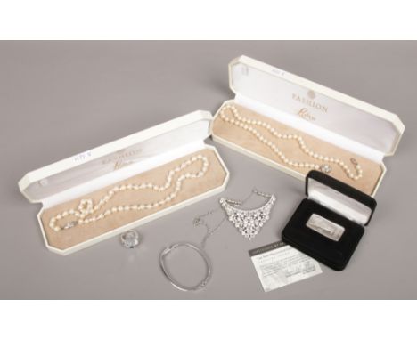 A cased Franklin Mint fine silver .999 troy ounce 31.34 grams ingot with certificate of authenticity, along with a Swarovski 