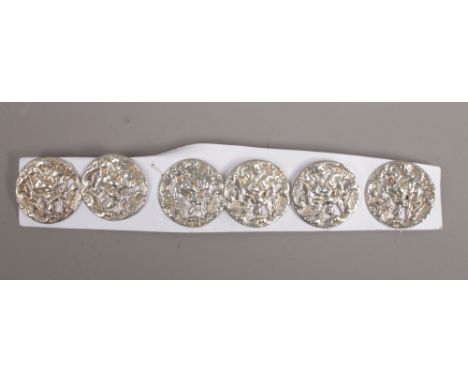 A set of six Victorian pierced silver buttons by King &amp; Sons. Depicting a Classical maiden with bow and arrow and a hound
