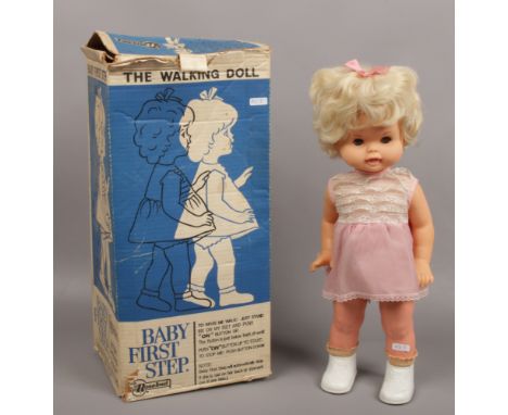 A 1960s battery powered baby first steps doll in original box by Rosebud Mattel. 