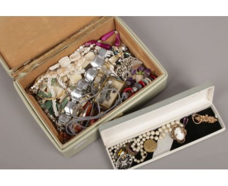 A leather jewellery box containing various costume jewellery items including Pinchbeck cameo brooch, panel bracelets and lock