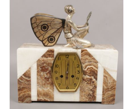 An Art Deco marble and onyx mantel clock with mounted metal fairy. 
