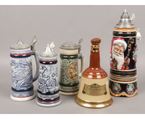 Four steins to include musical example, along with a Bells Whisky decanter 