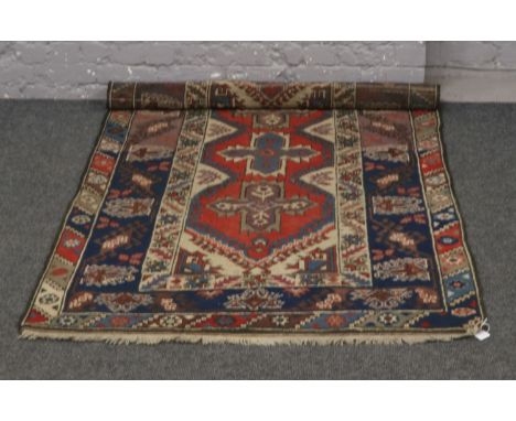 A Persian wool rug with central panel decoration, 200cm x 120cm. 