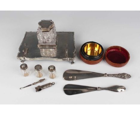 An Edwardian silver serpentine fronted rectangular inkstand, inscription engraved, the centre fitted with a silver mounted sq