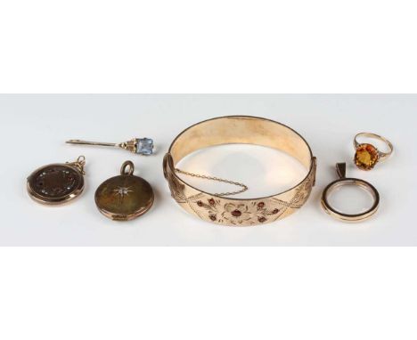 A gilt metal and garnet oval hinged bangle with floral decoration, on a snap clasp, inside width 6.1cm, a 9ct gold mounted ci