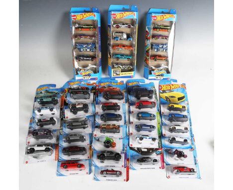 A collection of Mattel Hot Wheels vehicles, all within bubble packs.