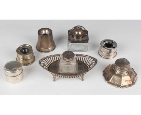 A late Victorian silver inkstand of oval form with pierced sides and gadrooned rim, fitted with a central square cut glass in