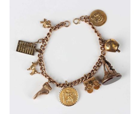A 9ct gold curblink charm bracelet on a boltring clasp, detailed ‘9ct’, fitted with seven 9ct gold charms, a cowbell detailed