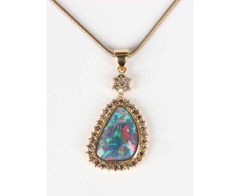 A gold, opal triplet and tinted brown diamond drop shaped pendant, unmarked, weight 12.5g, length 4.3cm, with a gold Brazil l