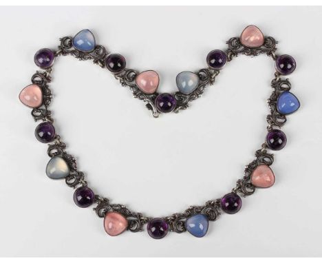 A silver and varicoloured cabochon quartz necklace with scroll engraved decoration, on a hook clasp, London 1956, maker’s mar