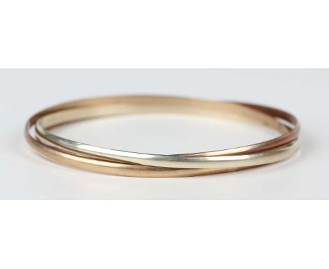 A 9ct three colour gold triple hoop Russian style bangle, London 1987, weight 14.1g, inside diameter 6.2cm.