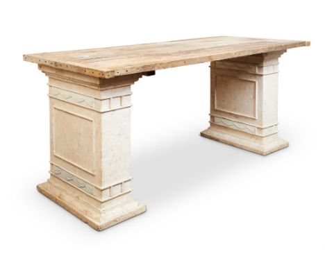 A CONSOLE TABLE20TH CENTURYThe cleated plank pine top above a pair of architectural plaster standard supports with classical 
