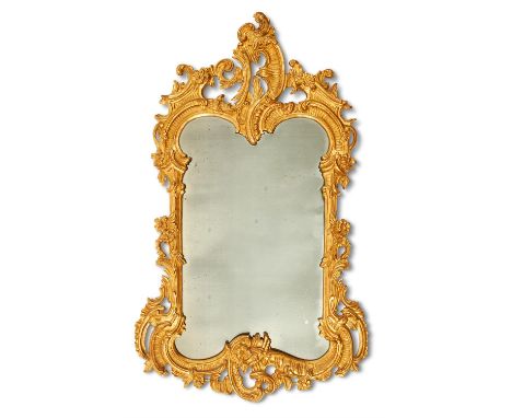 A GILTWOOD WALL MIRROR IN BAROQUE TASTECIRCA 1900The frame pierced with 'C'-scrolls around the plate150cm high, 92cm wideCond
