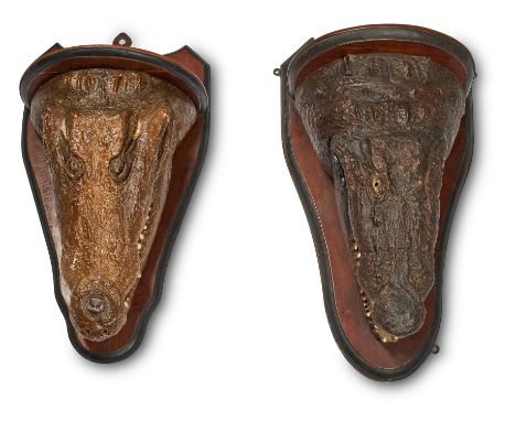 A COMPANION PAIR OF CROCODILE HEAD WALL BRACKETSLATE 19TH CENTURYOne modelled with mouth agape, the other closed 86cm and 77c