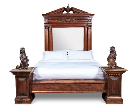 A LARGE CARVED MAHOGANY BED19TH CENTURY AND LATEROf archictural form, the headboard with mirror back, the footboard with flan