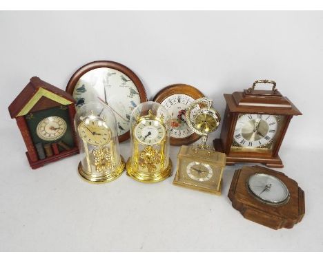 A box of various mantel and wall clocks and an oak cased barometer.