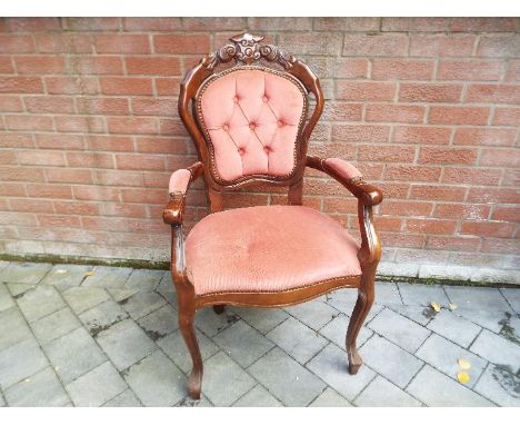A button back armchair with red upholstery