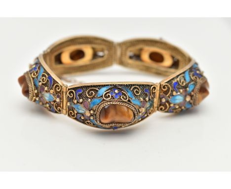 A GEMSET BRACELET, comprised of five domed panels with filigree and enamel detail, each panel set with a polished tigers eye 