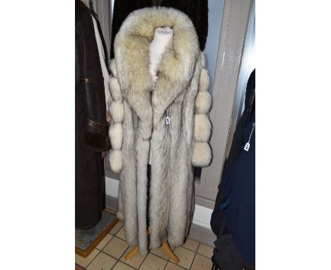 TWO LADIES LONG FUR COATS, comprising a cream and brown tipped Artic fox fur coat with pale grey leather panels and large sha