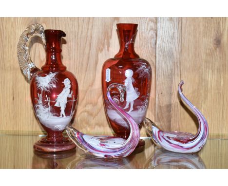 A SMALL COLLECTION OF GLASS WARES, comprising a Mary Gregory cranberry and clear glass jug, painted with a figure looking at 