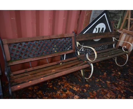 A WEATHERED WROUGHT IRON STRAPWORK GARDEN BENCH, length 140cm, along with a cast aluminium garden bench, length 126cm (condit