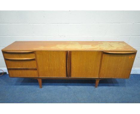 A MID CENTURY TEAK MCINTOSH SIDEBOARD, fitted with three drawers, two cupboard doors and a fall front door that's enclosing a