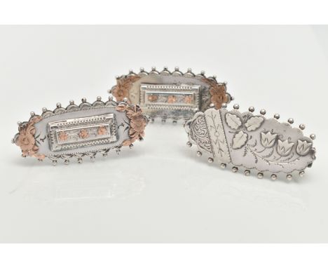 THREE LATE VICTORIAN SILVER SWEETHEART BROOCHES, each of an oval form, applied bead work surround, two with rose gold floral 