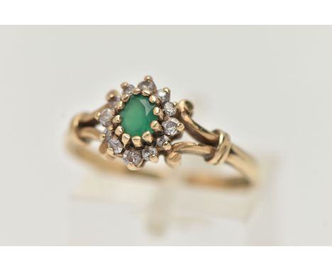 A 9CT GOLD GEMSET RING, an oval cut green chalcedony, set with a surround of circular cut cubic zirconia, leading on to scrol