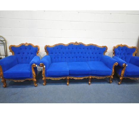 A REPRODUCTION FRENCH THREE PIECE LOUNGE SUITE, with flamboyant scrolled carving and detail, on front cabriole legs, upholste