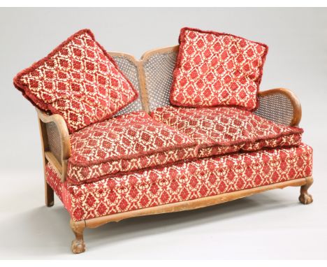 A 1930'S WALNUT BERGERE SOFA, with two-panel back and ball and claw feet. 137cm long