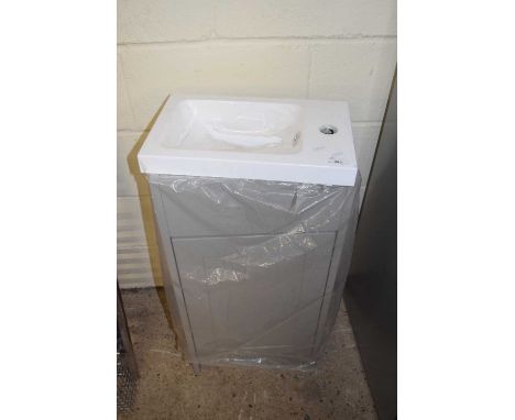 Small, as new, bathroom basin on cabinet