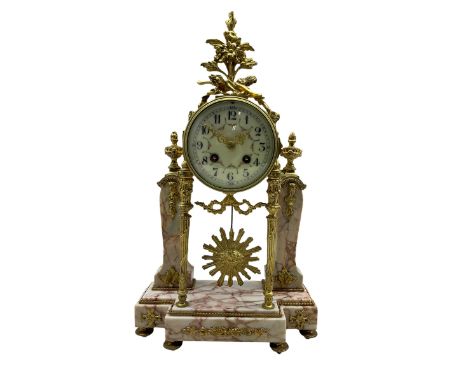 A late 19th century French portico clock on a break front variegated marble base with two conforming marble pillars, with a g