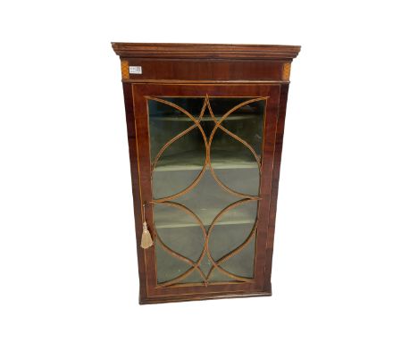 George III mahogany corner wall cabinet, the glazed door of tracery design enclosing three fixed shelves 