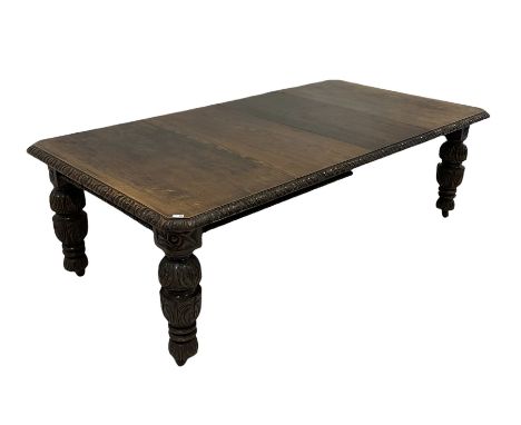 Victorian oak extendable dining table, the extending top with carved edge over profusely carved turned supports, terminating 