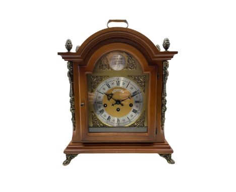 A contemporary German replica of an 18th century style bracket clock in a light mahogany break arch case, with carrying handl