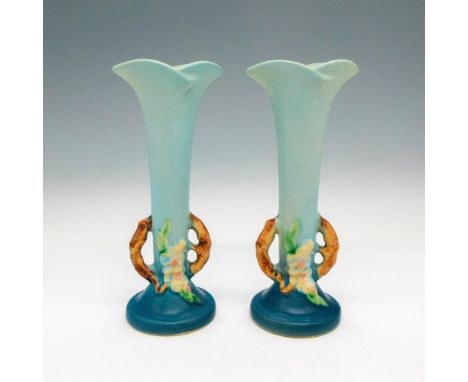 Lightly glazed, flared edged top with gradient light blue to dark blue. Double handles are colored and designed as branches. 