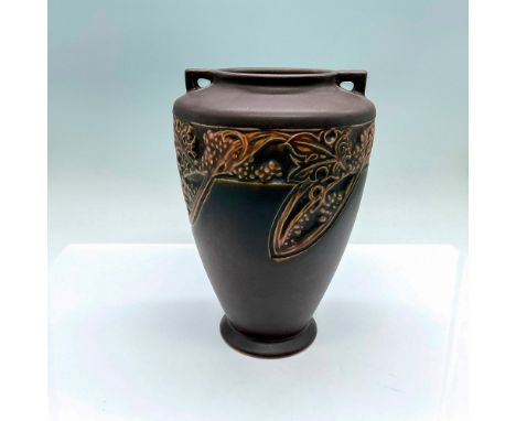 A two-handled vase decorated in a brown semi-matte finished and adorned in an Art Nouveau style grape pattern. R stamped on t