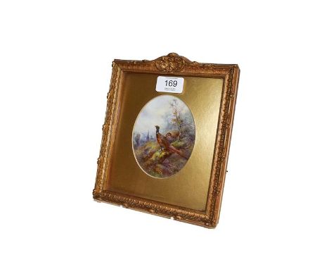 A Royal Worcester plaque by James Stinton, the oval porcelain plaque painted with pheasants in landscape with church beyond i