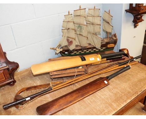 Two cricket bats one signed with a former Yorkshire team, two hickory shafted golf clubs, a lacrosse stick, two vintage tenni