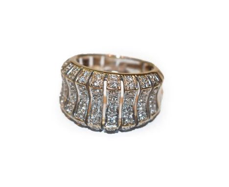 A diamond ring, formed of graduated undulating panels set throughout with eight-cut diamonds, in white claw settings, finger 