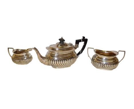 A three-piece Victorian silver tea-service, London, 1895, each piece with part-fluted lower body, comprising a teapot with eb