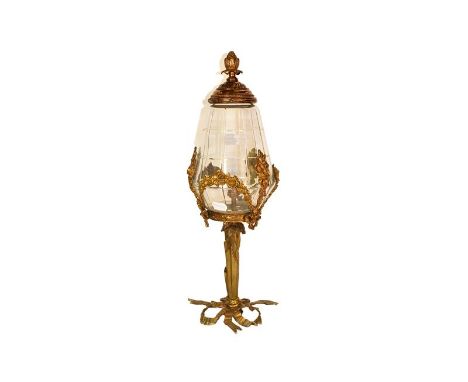 A French ormolu and glass lamp with ribbon and foliate swag detail, 55cm high.  Not wired. Visble glass free from cracks and 