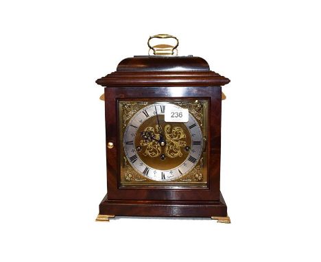 A modern mahogany cased table clock on brass bracket feet, with 6'' brass square dial having silvered chapter ring and signed
