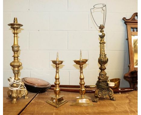A pair of 19th century brass candle prickets, two other metal table lamp bases, a copper warming pan and a similar brass item