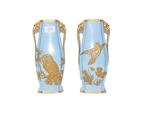 A pair of 19th century Royal Worcester vases decorated with raised gilded foliage and birds with twin handles with lion masks
